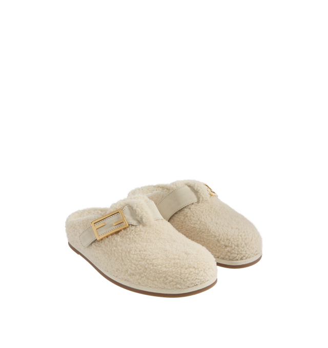 Image 2 of 4 - WHITE - Fendi Women's Feel Sheepskin round-toed sabots with FF strap. Made of white sheepskin. White split leather details. Gold-finish metalware. Made in Italy.  Composition: 100% sheep fur, 100% calf leather, inside: 100% calf leather, 100% sheep fur. 