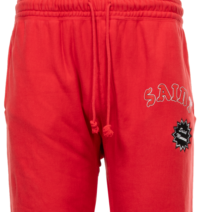 Image 4 of 5 - RED - SAINT MICHAEL Sweat Pants featuring elastic waist with drawstrings, side pockets and back pocket, logo on leg, no side seam and elastic hem. 100% cotton. 