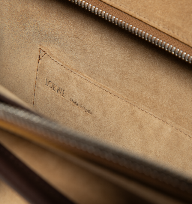 Image 5 of 5 - BROWN - Loewe Mens Amazona 180 XL Bag is crafted from suede with soft calfskin details. Features a relaxed silhouette, single toron top handle, removable shoulder handle, adjustable crossbody strap, zip closure with two leather pullers, two compartments with concealed magnetic closure, interior flat pocket, side D-ring, suede and nappa lambskin lining, palladium-tone hardware, and embossed LOEWE and Double L branding. Dimensions: 40  31  16 cm; Strap Length: 105133 cm; Strap Drop: 4761 cm; Ha 