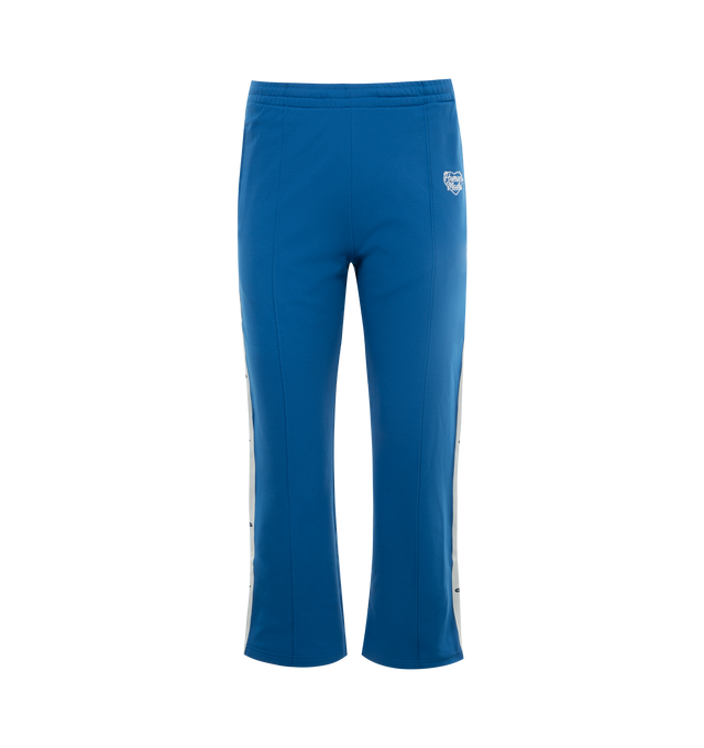 Image 1 of 3 - BLUE - HUMAN MADE Track Pants featuring the character graphic of "THE FUTURE IS IN THE PAST" on both sides, elastic waist, two side pockets and one back welt pocket. 100% polyester. 