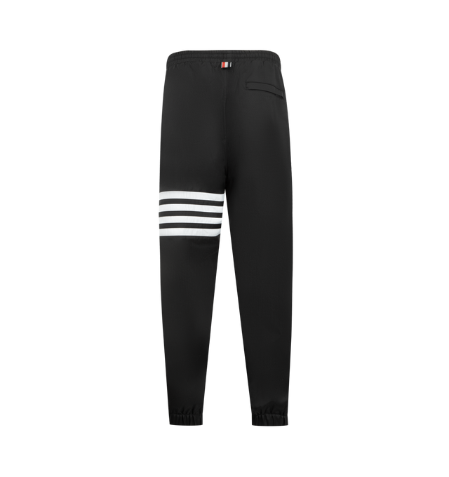 Image 2 of 3 - BLACK - THOM BROWNE Shiny Ripstop 4 Bar Track Pant featuring elasticated waistband with internal drawstring, zip fly, hand pockets and back pocket with hidden zips, elasticated cuffs, mesh lining, 4-bar detailing and signature striped grosgrain loop tab. 81% polyamide, 19% polyester. Made in Italy. 