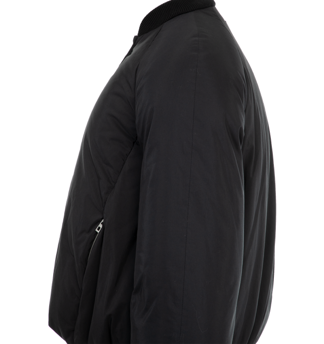 Image 3 of 3 - BLACK - Loewe Men's Bomber jacket crafted in lightweight water repellent technical cotton and fully lined. Regular fit, short length featuring an all over padded effect, ribbed collar, raglan sleeves, elasticated cuffs, zip front fastening, zipped seam pockets, inside welt pockets, elasticated hem and Anagram embossed leather patch placed at the back.  Cotton/Polyamide. Made in Italy. 