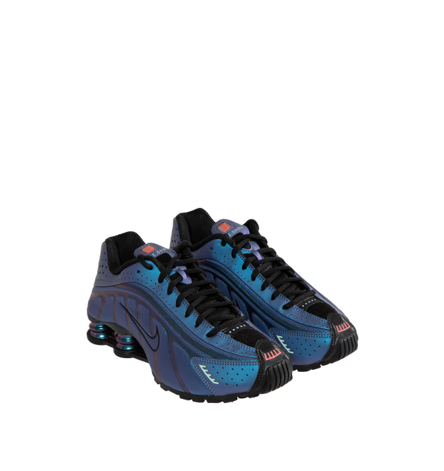 Image 2 of 5 - PURPLE - Nike Shox R4 featuring iridescent upper that shifts between shades of purple and blue. Featuring perforated detailing,  signature Shox pillars in the heel for enhanced impact protection, black accents on the laces and midsole. 