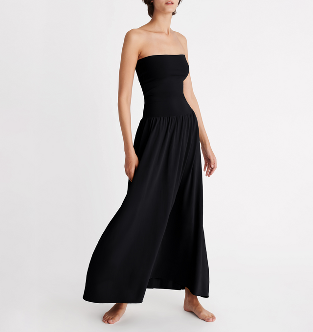Image 2 of 5 - BLACK - ERES Oda Long Dress featuring long bustier dress with a raw edge finishing at the top and bottom that gives you the styling option to wear it as a long skirt. Main: 94% Polyamid, 6% Spandex. Second: 84% Polyamid, 16% Spandex. Made in France. 
