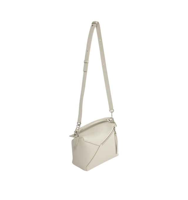 Image 2 of 3 - WHITE - LOEWE Small Puzzle Bag has a zipper closure, removable and adjustable shoulder strap, exterior zip pocket, interior slip pocket, and embossed signature Anagram. Lined. Measures 6.5 inch high X  9.4 inch wide X 4.1 inch deep. 100% calf leather. Made in Spain.  