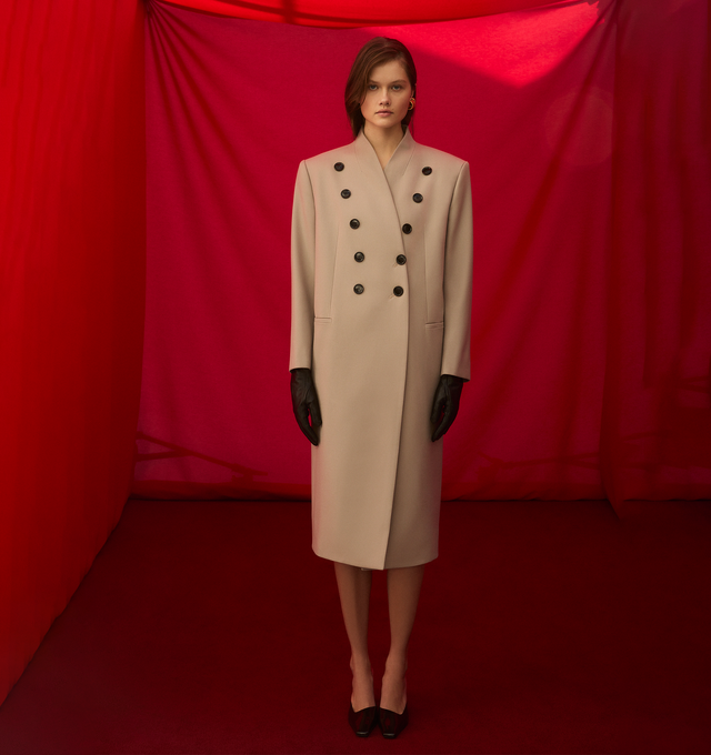 Image 3 of 3 - NEUTRAL - ALAIA Large Coat featuring buttons in a v shape, horn buttons, signature alaa upstitching, v neck and made from japanese wool gabardine. 100% virgin wool. Made in Italy 