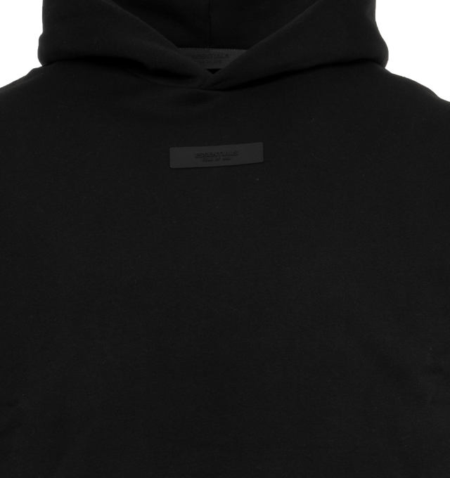 Image 4 of 4 - BLACK - FEAR OF GOD ESSENTIALS Hoodie featuring elastic waist and cuffs, fixed hood, side pockets and rubber logo on chest. 100% cotton.  