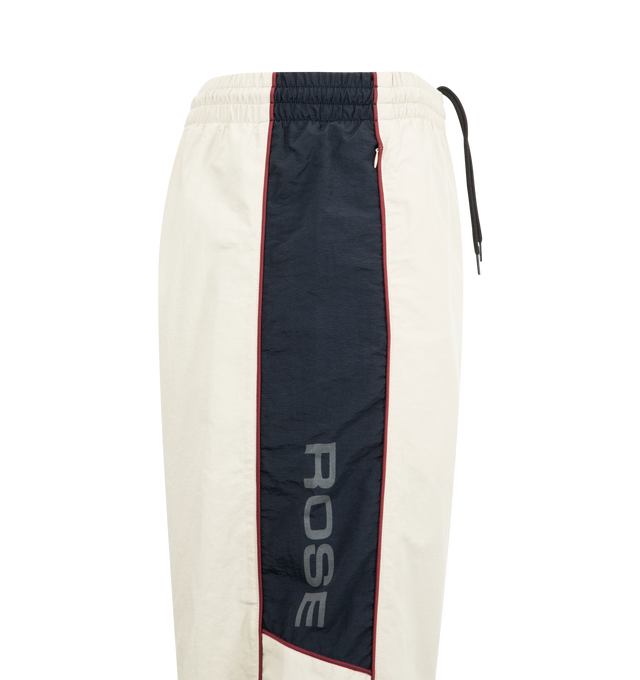 Image 3 of 3 - WHITE - MARTINE ROSE Hockey Trackpants featuring side stripe detailing, logo print, elasticated ankles, side pockets, panelled design and elasticated waistband. 100% polyamide. 