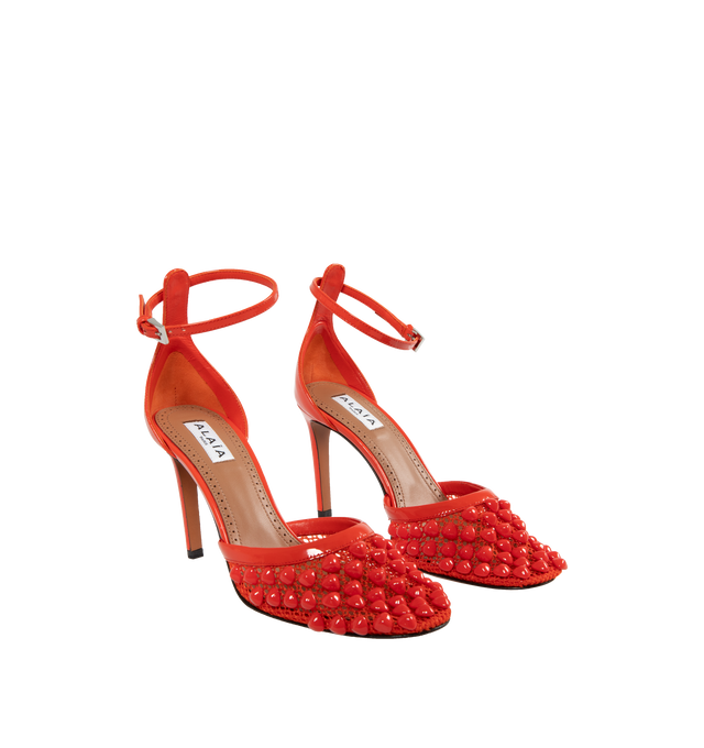 Image 2 of 5 - ORANGE - Alaia Fishnet Stud Pumps have pyramid studs embedded in mesh and adjustable ankle straps. 100% lambskin. Made in Italy.  