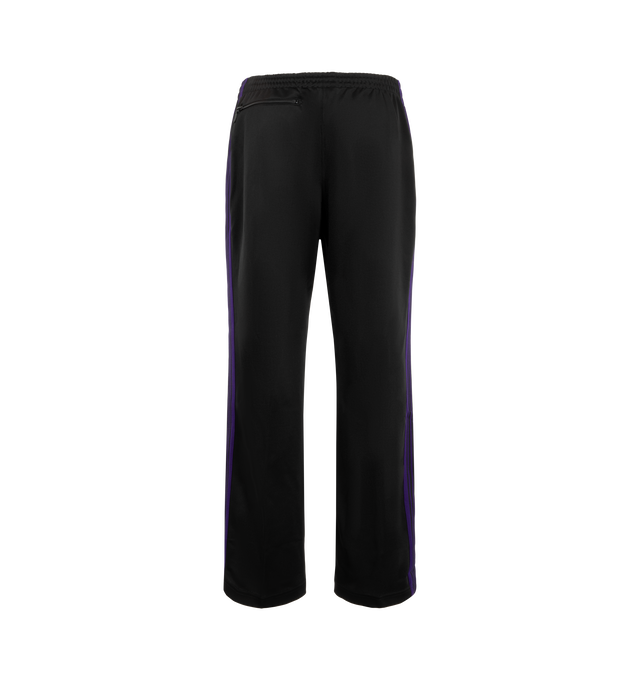Image 2 of 3 - BLACK - Needles Men's Track Pant - Poly Smooth is crafted from smooth polyester jersey and features the brands signature track pant silhouette with side stripe detailing and embroidered branding. Designed for a relaxed fit, this athletic-inspired style combines comfort and versatility with a streamlined profile and elasticized waistband. Main Material: Polyester. Fit: Relaxed. Waist: Elasticized. Details: Side Stripes, Embroidered Logo. Made in Japan. 