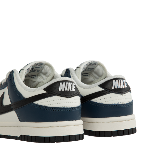 Image 3 of 5 - BLUE - Nike Dunk Low Sneakers with white and midnight navy color-blocking with a black swoosh,  a padded, low-cut collar, leather upper with a slight sheen and durability, foam midsole offering lightweight, responsive cushioning. Perforations on the toe add breathability. Rubber sole with classic hoops pivot circle provides durability and traction. 