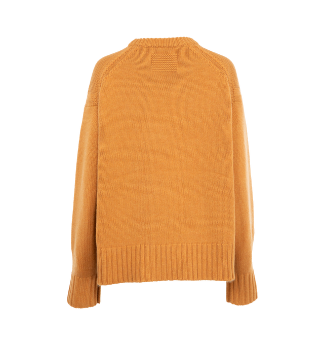 Image 2 of 3 - ORANGE - GUEST IN RESIDENCE Cozy Crew featuring oversized fit, crew neck, dropped shoulder, reverse jersey detail around arm & shoulder with tuck stitch, ribbed neck trim, cuff and hem, side slit at hem and jersey cable. 100% cashmere.  