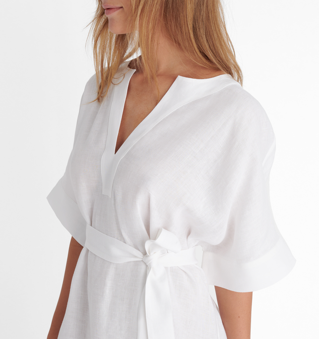Image 4 of 4 - WHITE - ERES Bibi Kaftan featuring short sleeves, V-neckline, pleated back, removable belt without loop, rounded slits on each side at the bottom and length above ankles. 100% Linen. Made in Bulgaria. 