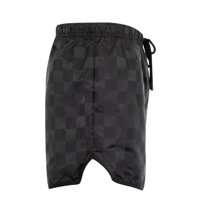 Image 3 of 3 - BLACK - Fear of God Essentials Mens Checkered Gym Shorts are crafted from nylon. Feature a relaxed fit, and an elasticized waistband with drawstring. Main Material: Nylon.  
