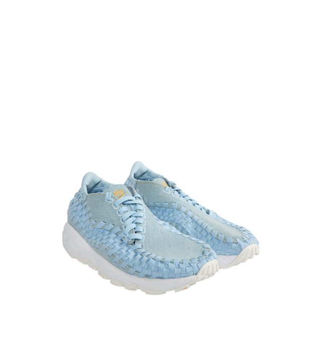 Image 2 of 5 - BLUE - NIKE Air Footscape Woven Sneakers featuring a pale blue colored textile and soft suede upper, asymmetrical woven details, lateral lacing, foam midsole, Nike Air cushioned heel and rubber outsole. 