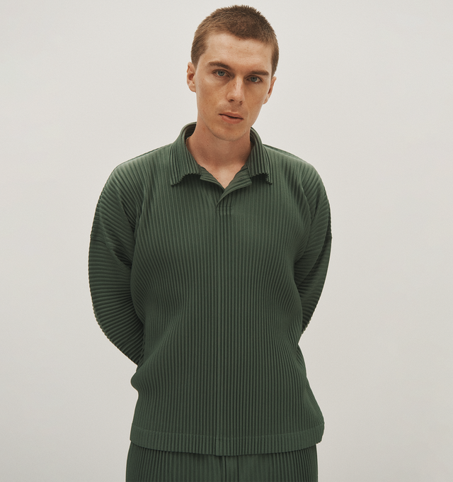 Image 4 of 5 - GREEN - Homme Plisse Issey Miyake solid polo shirt with allover pleating featuring spread collar, hidden two-button placket, long sleeves, relaxed fit, pullover style. Made in Japan. Polyester 100%. 