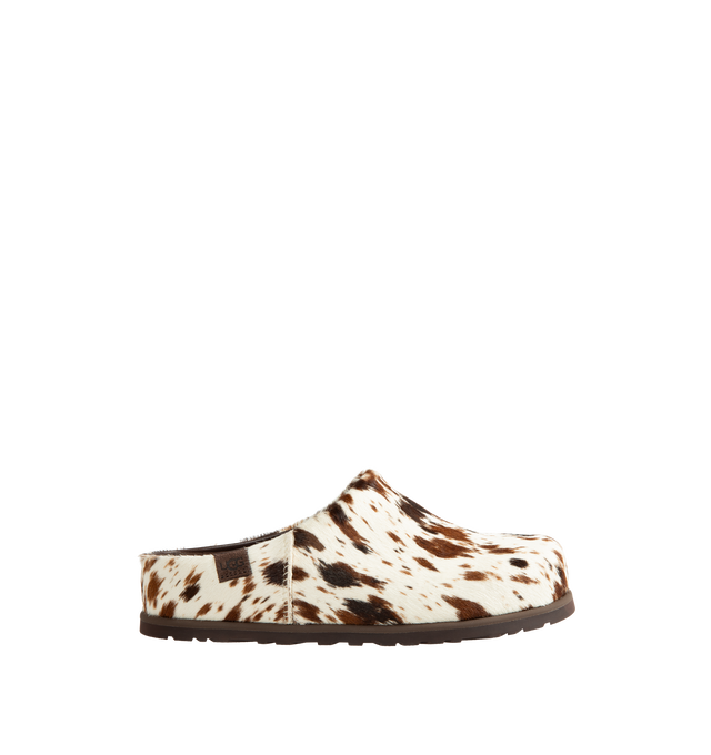 Image 1 of 4 - BROWN - Ugg Men's Otzo Western Clog is crafted with a hand-painted cow hair upper and reimagines the brands signature clog silhouette through a Western-inspired lens. Designed for all-day comfort, this distinctive style features a leather and RWS wool jersey lining enhanced with a peppermint-based anti-odor treatment, along with a contoured EVA footbed for cushioning and support. A leather and microfiber sockliner provides additional comfort, while the lightweight rubber outsole with 30% FCS- 
