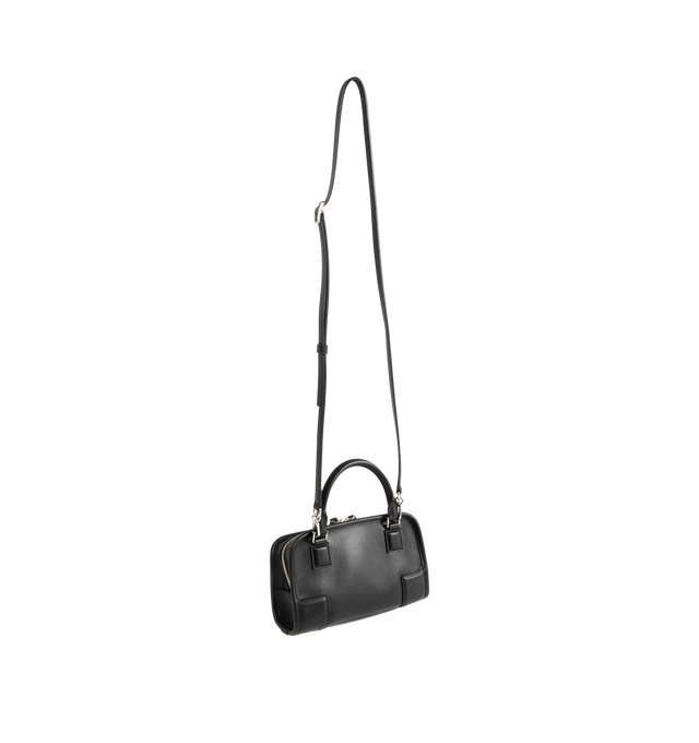 Image 2 of 4 - BLACK - Loewe Mini Amazona 180 Bag in leather features a relaxed silhouette anchored by a single toron top handle, designed to be carried open, while a concealed closure secures the main compartment, removable shoulder and crossbody straps, two carry options: short handle, removable and adjustable crossbody strap, zip closure with two leather zip pullers, two compartments, main compartment closed with magnetic closure, left side d-ring for customization, suede and nappa lambskin lining, and e 