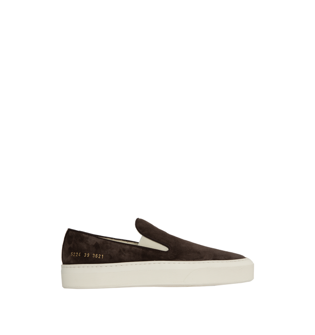 BROWN - Common Projects minimalist slip-on sneaker crafted from calf suede in a sleek, round-toe profile with thick rubber soles detailed at the heels with signature gold serial number stamp. Made in Italy.