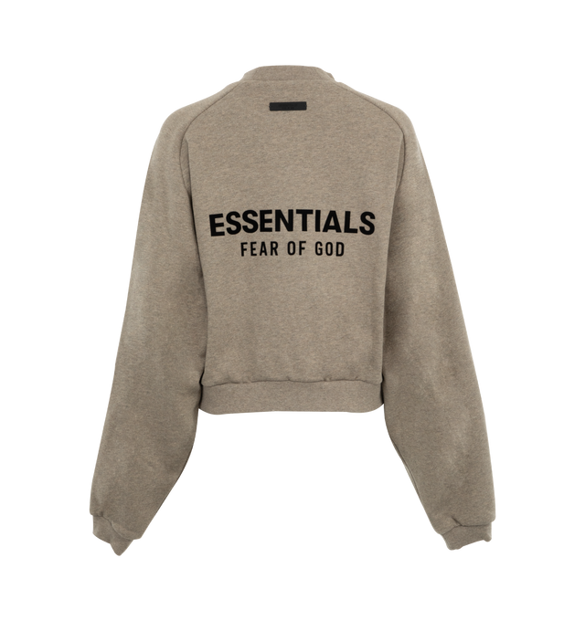 Image 2 of 3 - GREY - Fear of God Essentials Womens cropped crewneck sweatshirt in a pullover style with long sleeves, two slip pockets at front, embossed brand print at front and back, and ribbed trims. 80% cotton, 20% polyester.  