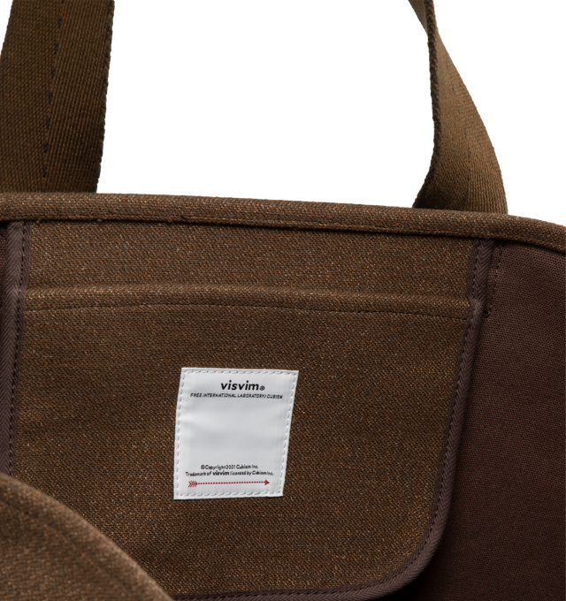 Image 3 of 3 - BROWN - VISVIM Comber large bag with canvas exterior and lining featuring one main compartment with single interior flat pocket. Measures approx 23" W x 15" H x 6.25" D. 62% wool, 38% linen. Lining: 100% cotton. 