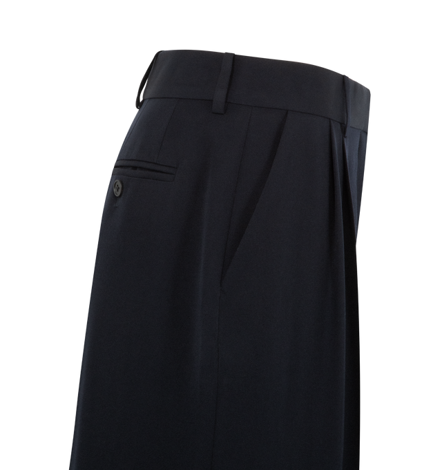Image 5 of 5 - NAVY - THE ROW Lior Pant featuring tailored low-rise trouser in fluid Japanese wool gabardine with wide cuffed leg, front double pleats, and side slash pockets. 100% wool. Made in Italy. 