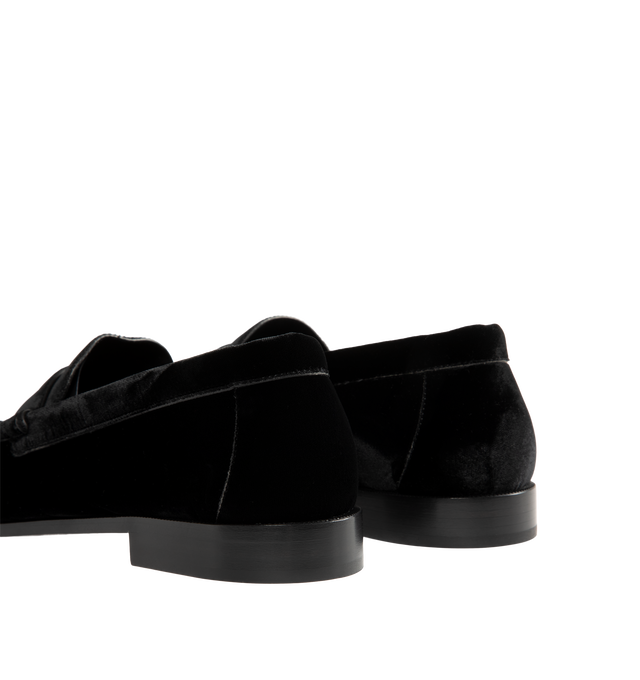 Image 3 of 4 - BLACK - Saint Laurent Men's Cassandre Velvet Penny Loafers are crafted from plush velvet and feature a supple silhouette with a hand-stitched moc toe for a refined finish. Designed with a classic penny loafer profile, these designer shoes are accented with the signature Cassandre in gold-tone brass hardware and finished with a leather sole and low stacked heel. Main Material: Velvet. Hardware: Brass. Sole: Leather. Heel Height: 1.5 cm / 0.6 in. Details: Gold-Tone Cassandre Hardware, Hand-Stit 