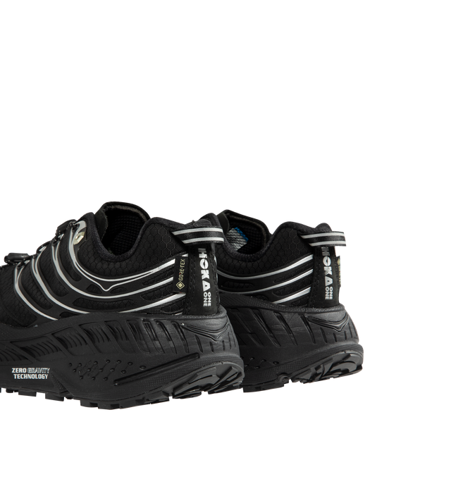 Image 3 of 5 - BLACK - HOKA Stinson EVO GTX Sneaker featuring ripstop upper, nubuck toe and heel overlays, waterproof GORE-TEX bootie construction, reflective webbing heel pull, speed-lace system and secondary lace option. 