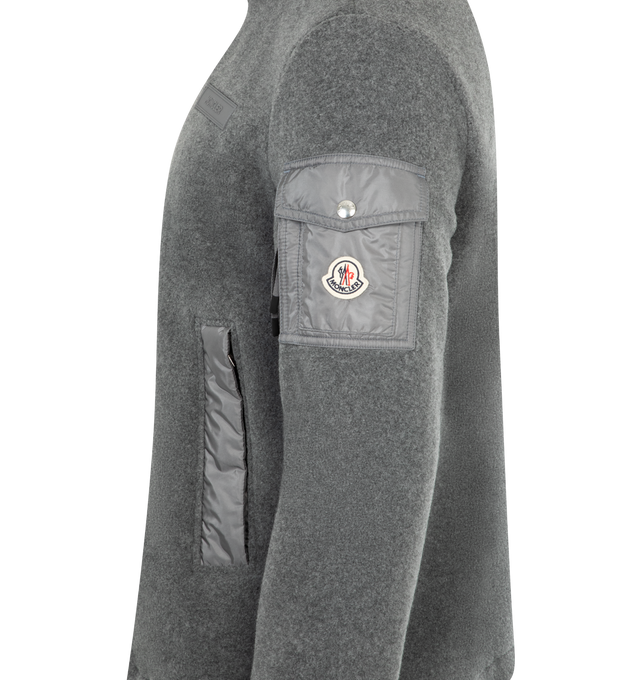 Image 3 of 3 - GREY - MONCLER Fleece Jacket featuring a snap-flap sleeve pocket, two-way front-zip closure, stand collar, elastic cuffs and front welt pockets. 100% polyester. Made in Romania. 