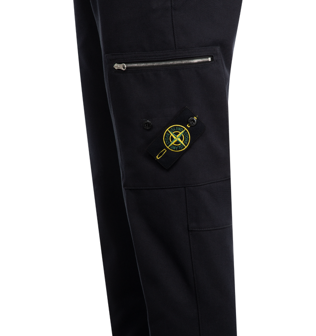 Image 3 of 3 - NAVY - STONE ISLAND Trousers featuring a front zip and button fastening, belt loops, two zipped side welt pockets, a back welt pocket and a patch pocket on the side with zip and Compass logo label. 55% cotton, 45% polyamide. 