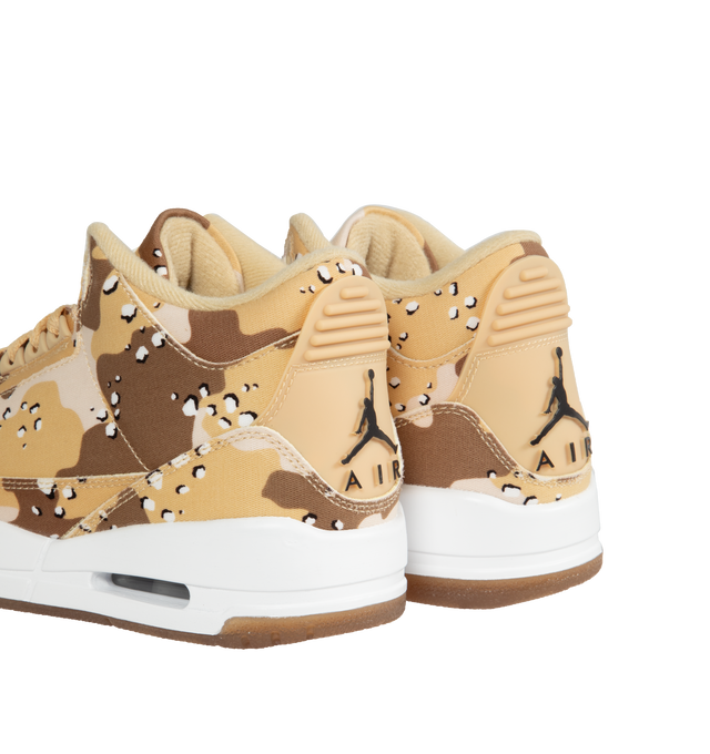 Image 3 of 5 - NEUTRAL - Women's Air Jordan 3 lace-up sneakers with  Desert Camo textile upper, raised Jumpman logo at the tongue, vibrant hits of Brilliant Orange on the bottom of the sole, plus a coordinating dog tag accessory. 