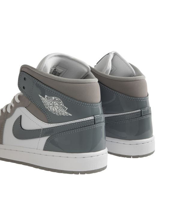 Image 3 of 5 - WHITE - Jordan Air Jordan 1 Mid SE Sneakers are a lace-up, high-top style with real and synthetic leather uppers, Nike Air technology cushioning, logos on the collars and tongues, padded, mid-top collars, and rubber outsoles.  