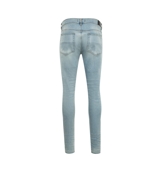 Image 2 of 3 - BLUE - Amiri MX1 Skinny Jeans are a 5-pocket style with a button and zip fly, distressing and rips overall, and a fitted silhouette with skinny legs. Polyester and elastane.  