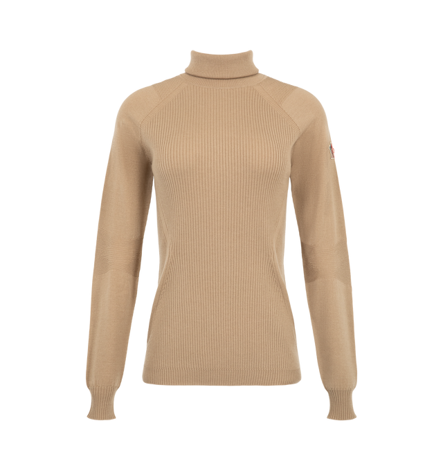 Image 1 of 1 - NEUTRAL - Moncler Grenoble Women's Wool Turtleneck Sweater is crafted from a stretch wool blend and features a fitted turtleneck silhouette designed for both mountain leisure and everyday winter wear. Knitted in a refined gauge 18 construction, this versatile layer offers lightweight warmth, flexible comfort, and is finished with subtle logo detailing. Main Material: 95% Virgin Wool, 5% Polyester. 