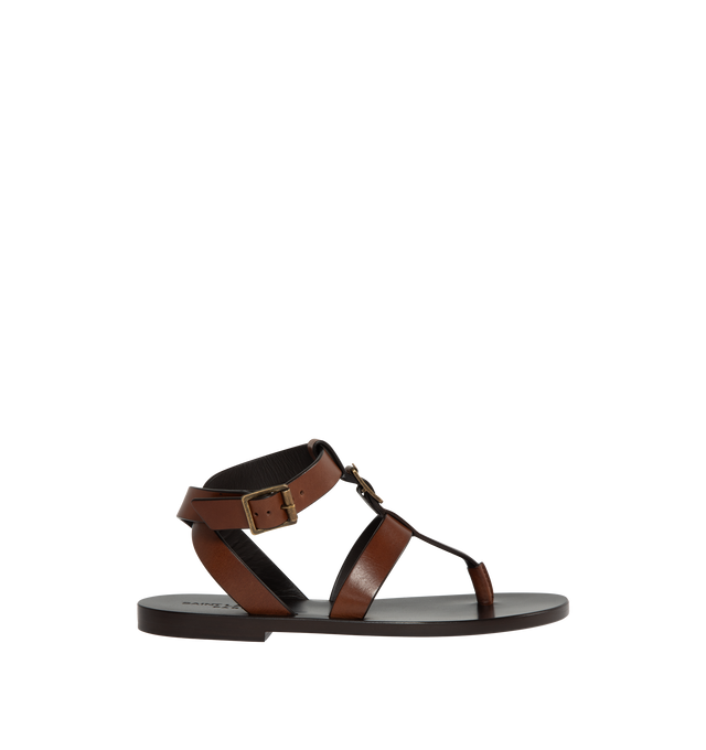 BROWN - Saint Laurent leather sandals featuring 5 mm flat heel, thong strap with buckle accent, adjustable ankle strap with a leather outsole. Made in Italy.