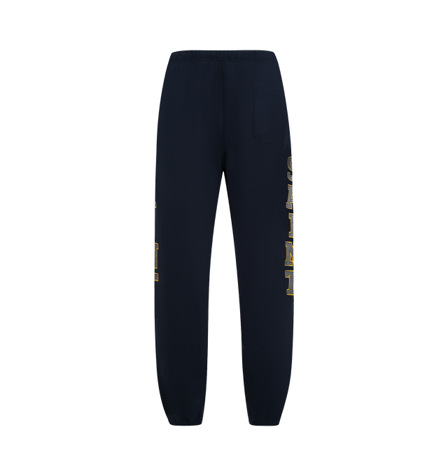 Image 2 of 3 - NAVY - SAINT MICHAEL Saint Sweatpants featuring elastic waist with drawstrings, side pockets, back pocket and graphic print down legs. 100% cotton. Made in Japan. 