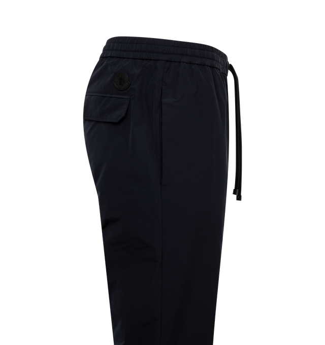 Image 3 of 3 - NAVY - MONCLER Jogging Pants featuring micro ventile lger, waistband with drawstring fastening, zipper closure, back pockets with snap button closure and leather logo patch. 100% polyester. 