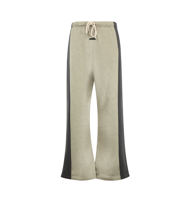 Image 1 of 3 - NEUTRAL - Fear of God Essentials Mens Lounge Pants are crafted from heavyweight 380 GSM cotton-blend core fleece. Feature a wide-leg fit, paneled construction, elasticized waistband with bungee drawcord, side-seam pockets, and an Essentials logo label. Main Material: 80% Cotton, 20% Polyester. 