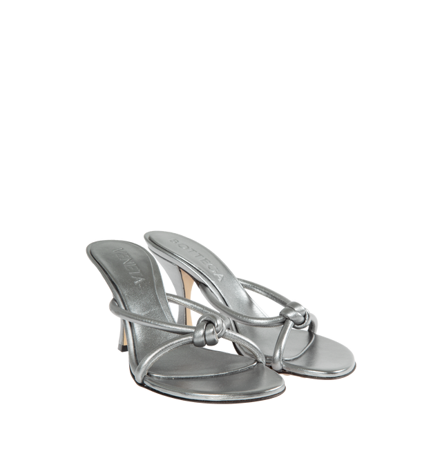 Image 2 of 4 - SILVER - BOTTEGA VENETA Blink Metallic Sandal featuring tubular straps of lambskin leather interlaced to the label's signature knot, asymmetric toe, pebbled rubber sole, cushioned footbed, leather upper and rubber sole. 95mm. Made in Italy. 