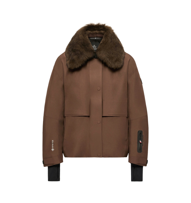 Image 1 of 1 - BROWN - Moncler Grenoble Women's Caurel GORE-TEX Shearling-Trimmed Insulated Ski Jacket is crafted from 2L GORE-TEX laminate and features a high-performance silhouette designed for skiing and snowboarding. Combining waterproof, windproof, and breathable protection with elevated alpine styling, this technical jacket is insulated with PrimaLoft Gold Active insulation and finished with a removable long-haired sheepskin collar for a refined mountain-inspired look. Built for demanding weather cond 