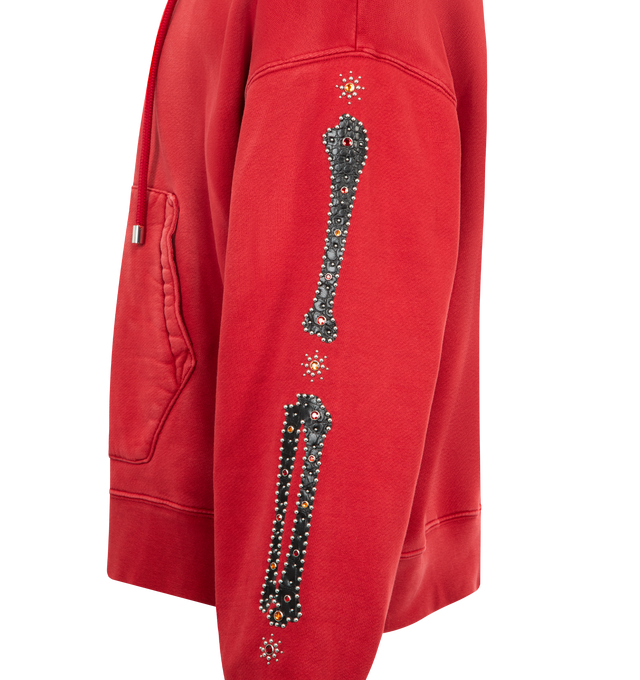 Image 3 of 3 - RED - AMIRI Bones Studded Zip Hoodie featuring oversized fit, zip front closure, bones appliques with stud detailing and front patch pockets. 100% cotton.  