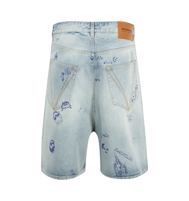 Image 2 of 3 - BLUE - Vetements Scribbled Denim Shorts are a 5-pocket style with a button fly, a logo patch at the back, silver-tone hardware, and fading, graphic, and text printed throughout. 100% cotton. Made in Italy. 