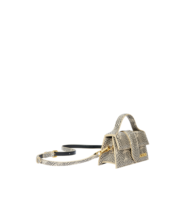 Image 3 of 4 - NEUTRAL - JACQUEMUS Bambino Bag featuring crossbody flap bag, structured, cobra-embossed leather, reinforced handle, magnetic flap, removable, adjustable shoulder strap, engraved lobster clip, card slot patch pocket on back, topstitching, gold metal logo and metalwork, fully lined and dyed edges. 13cm x 23.5cm. 100% goat leather. Lining: 100% cotton. Made in Italy. 