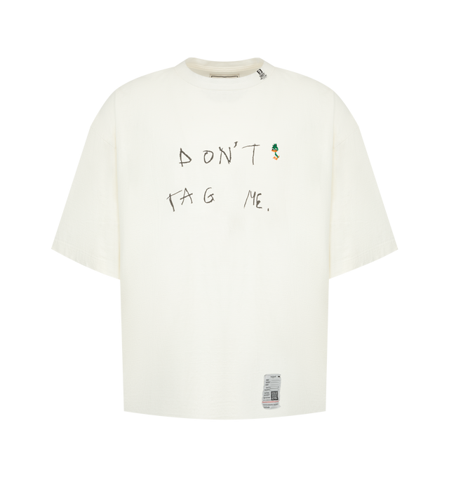 Image 1 of 2 - WHITE - Maison Mihara Yasuhiro Men's Don't Tag Me. Printed T-Shirt is crafted from cotton and features a classic crew neckline, short sleeves, and signature "Don't Tag Me." printed graphic artwork for a bold contemporary look. This designer graphic T-shirt combines soft everyday comfort with Maison Mihara Yasuhiro's distinctive streetwear aesthetic, making it an effortless statement piece. Main Material: 100% Cotton. Made in Japan. 