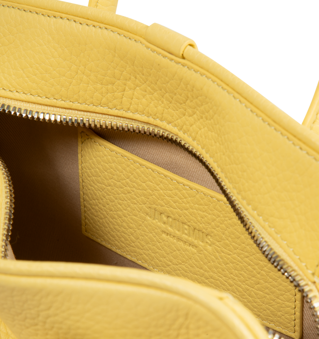 Image 3 of 3 - YELLOW - JACQUEMUS Turismo Small Bag featuring small soft bowling bag, gained leather, two-way zip closure, inside pocket, detachable and adjustable shoulder strap and bow detail. 26 cm x 16 cm x 11 cm. 100% calfskin. Made in Italy. 
