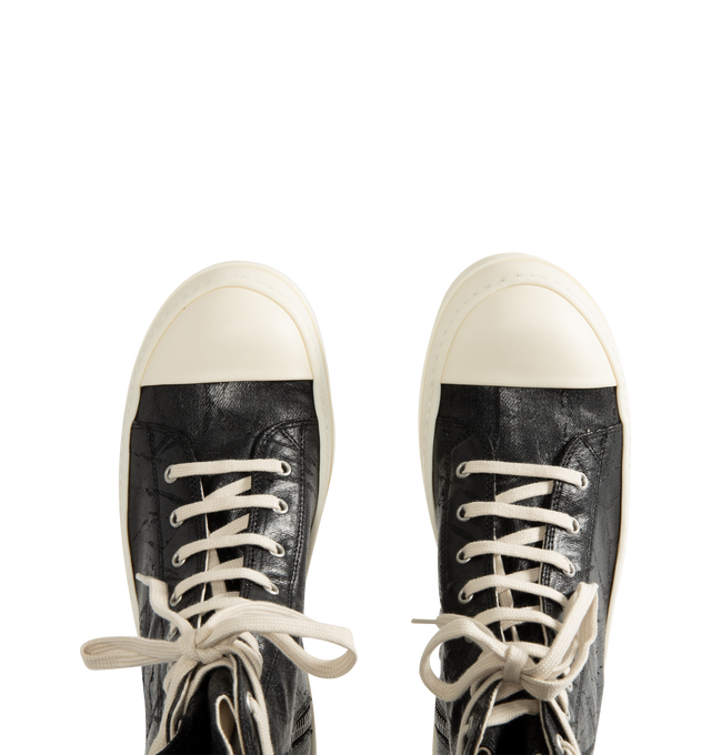 Image 5 of 5 - BLACK - Rick Owens DRKSHDW Men's Sneaks are crafted from 13 oz Megacrust Japanese denim and feature an above-ankle silhouette with eight eyelets, lace-up fastening, an interior ankle zipper, toe caps, and signature shark-tooth soles. Finished with a distinctive Megacrust treatment, the denim is overdyed black, wax-coated, and layered with black foil that naturally cracks and peels over time, creating a uniquely worn appearance with continued wear. Main Material: Upper 100% Cotton. Toe: 70% Po 