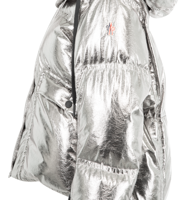 Image 4 of 5 - SILVER - MONCLER GRENOBLE Calaque Metallic Hooded Down Ski Jacket featuring metallic craquel, polyester lining, down-filled and padded, detachable and adjustable hood with teddy lining, YKK AcquaGuard highly water resistant zipper and snap button closure, pockets with snap button closure, inside media pocket with YKK AcquaGuard highly water resistant zipper closure, ski pass pocket, powder skirt, adjustable cuffs, hem with drawstring fastening and stretch jersey wrist gaiters. 100% polyester. 