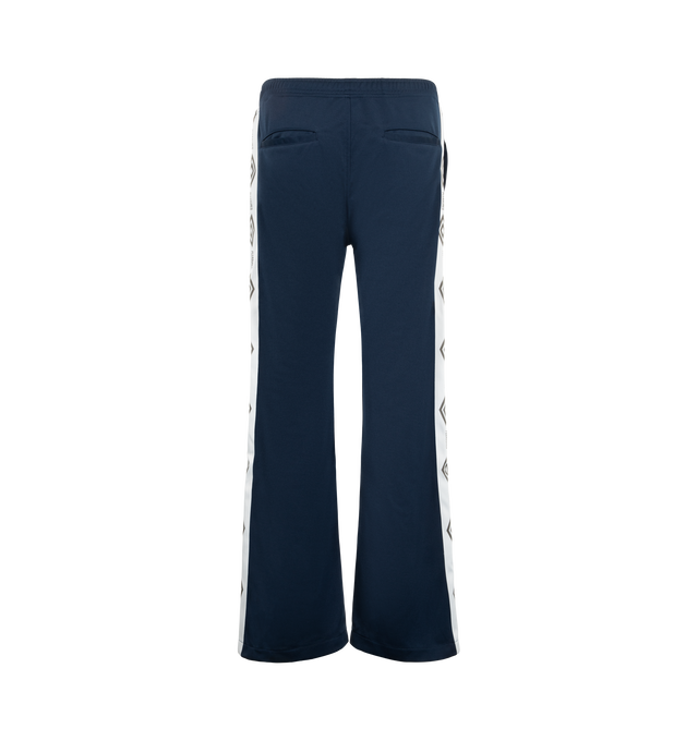 Image 2 of 3 - NAVY - Pleasures Men's Bootcut Track Pants are crafted from poly-tricot fabric and feature a streamlined bootcut silhouette. Designed for everyday comfort, the style is finished with signature jacquard taping along the sides for a sport-inspired look. Main Material: 100% Poly-Tricot 