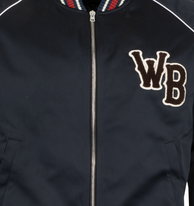 Image 3 of 3 - NAVY - Wales Bonner Men's Marvel Bomber Jacket with logo patch at chest and striped ribbed trims. Featuring crewneck, front zip fastening, long sleeves, snap-button fastening pockets at side, and rib trims. Made in Italy. 100% Polyester.  