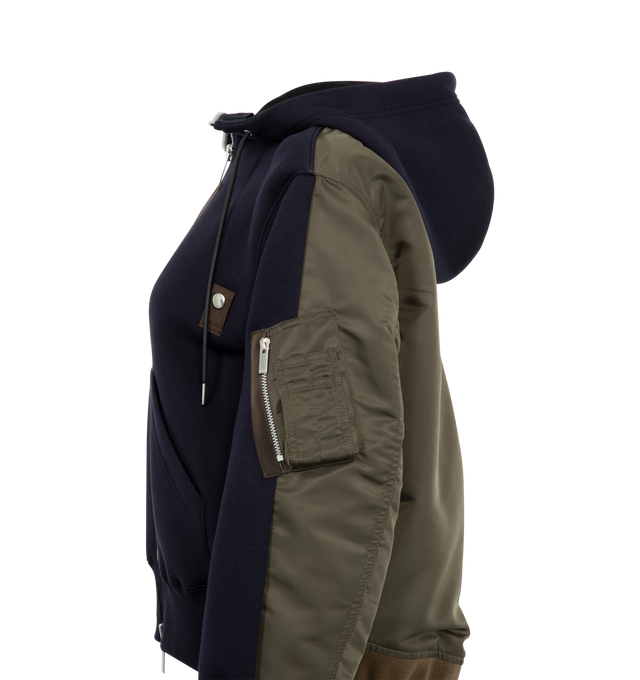 Image 3 of 3 - NAVY - SACAI Sponge x Nylon Twill Hoodie featuring zip front closure, drawstring hood, kangaroo pocket and zip pocket on sleeve and ribbed trims. 100% cotton. 100% polyester. Made in Japan. 